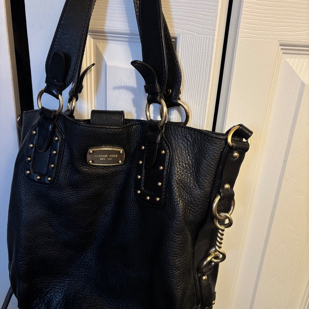 Tote handbag with attached crossbody strap.
